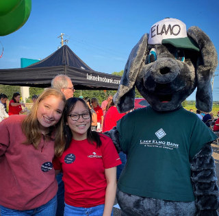 image of little elmo and two female staff